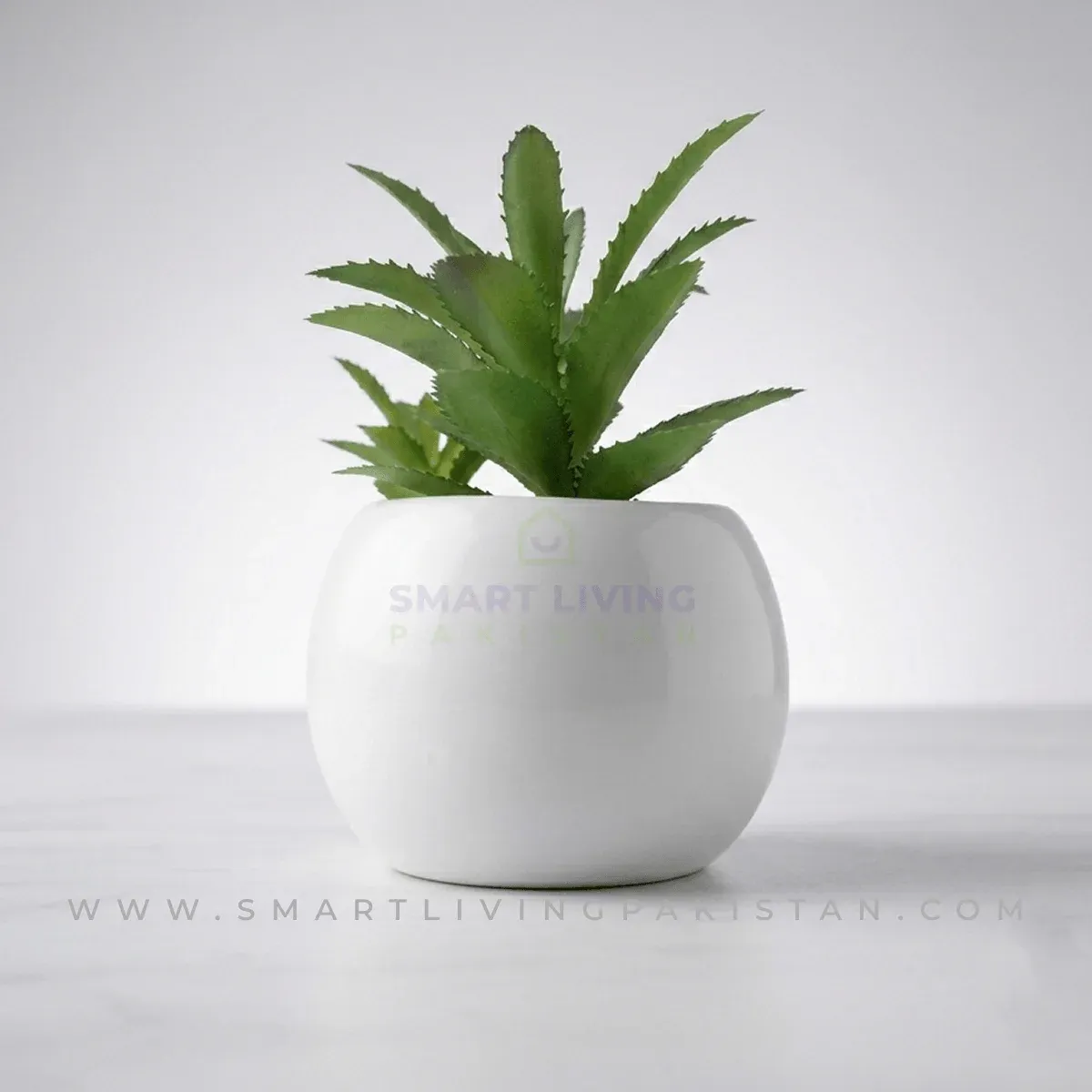 Mini artificial plant in white ceramic planter on kitchen counter, by Smart Living Pakistan
